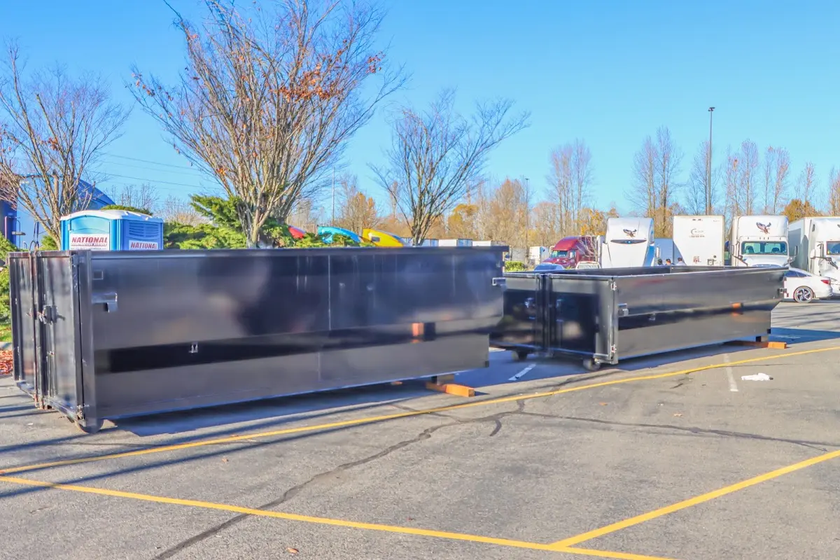 Professional dumpster rental service with roll-off container on residential driveway in Edinburg